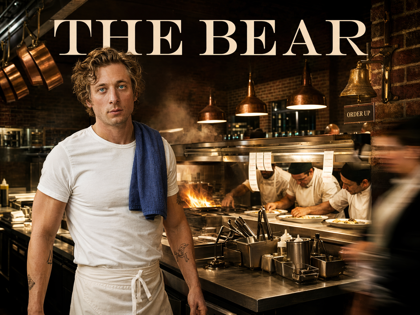 Jeremy Allen White as Carmen Berzatto in a white T-shirt with apron and blue dish-towel at the pass of a gleaming Chicago restaurant kitchen with line cooks plating behind him, The Bear title overlay.